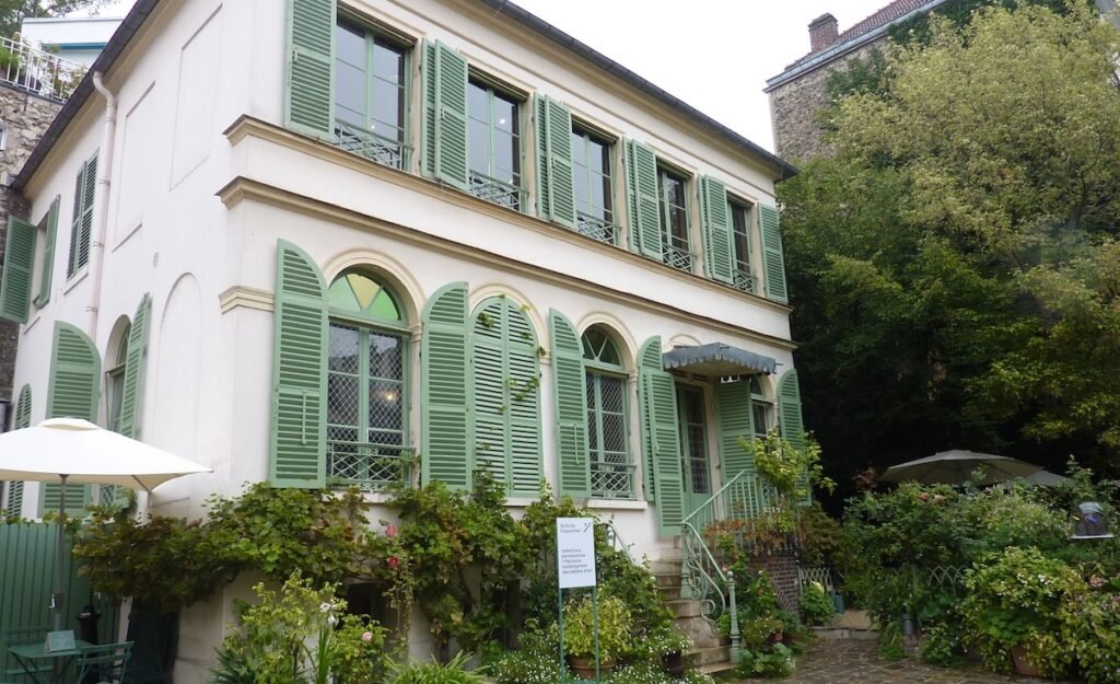a white building with green shutters